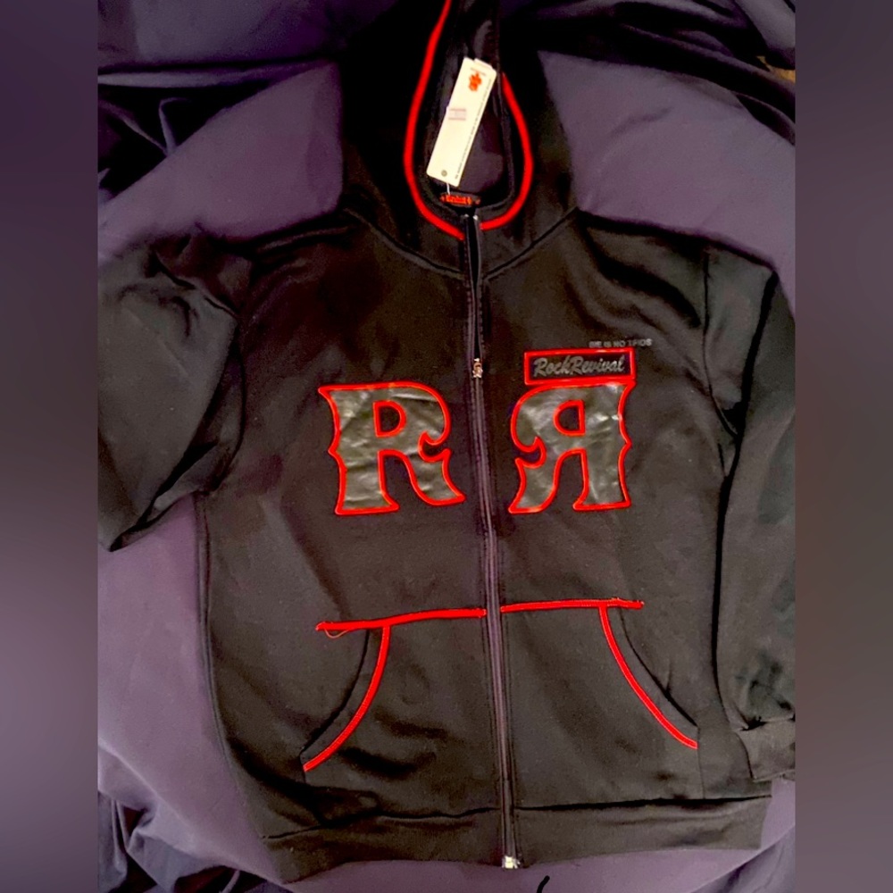 Men’s Rock Revival black zip up hoodie with red logo.